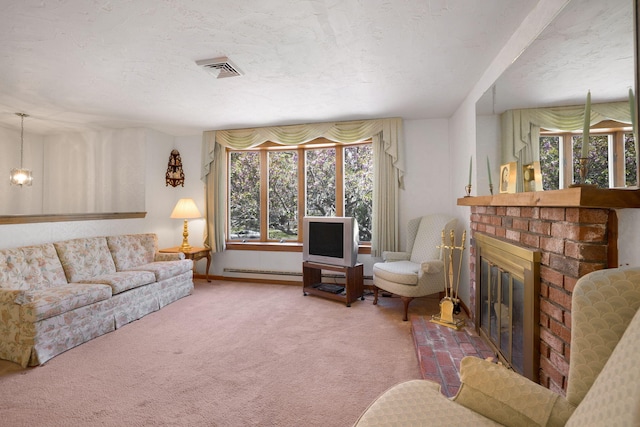 living area featuring a baseboard radiator, a fireplace, and carpet