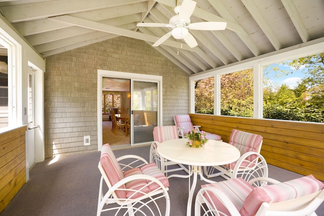 sunroom / solarium with a ceiling fan and outdoor dining space