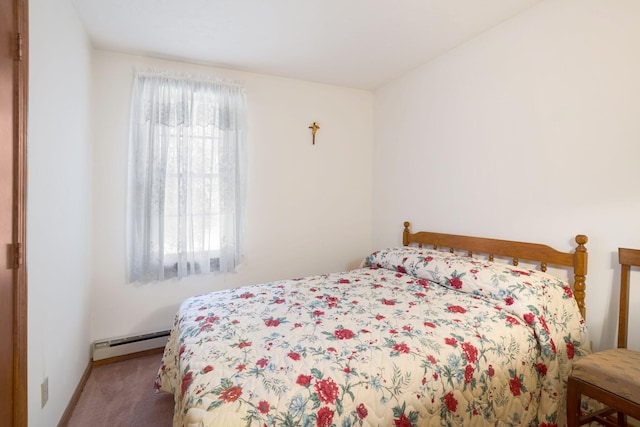 bedroom with a baseboard heating unit, carpet floors, and baseboards