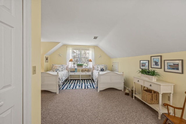 carpeted bedroom with visible vents and vaulted ceiling