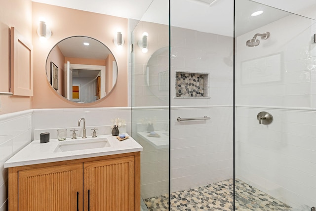 130 Daniels Dr, Wellfleet, MA 02667 - bathroom with a tile shower, vanity, and wainscoting