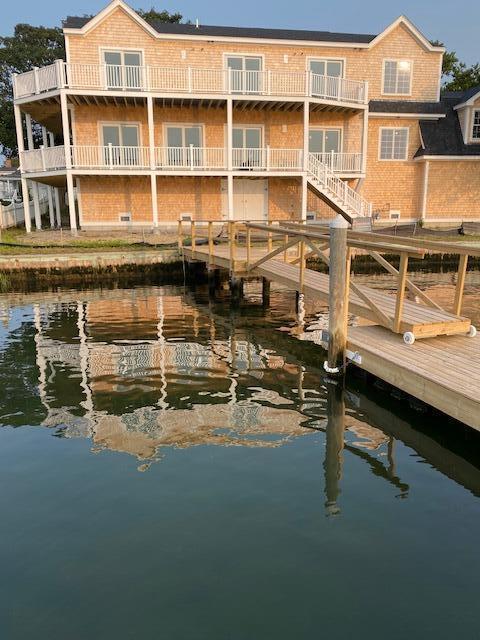 back of property with a water view