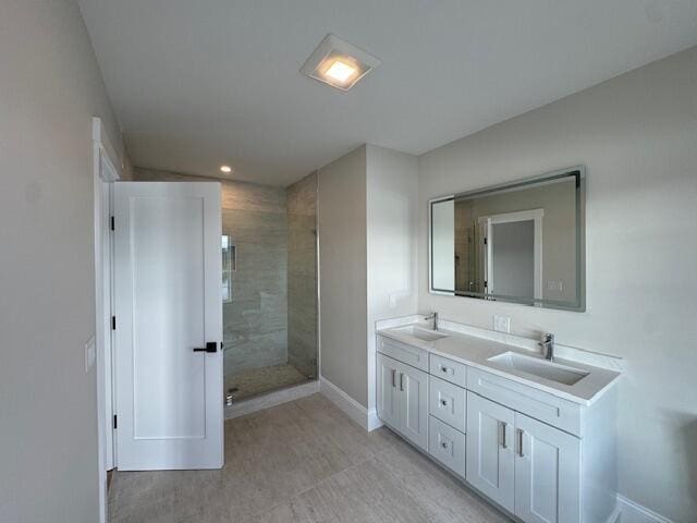 bathroom featuring a tile shower and vanity