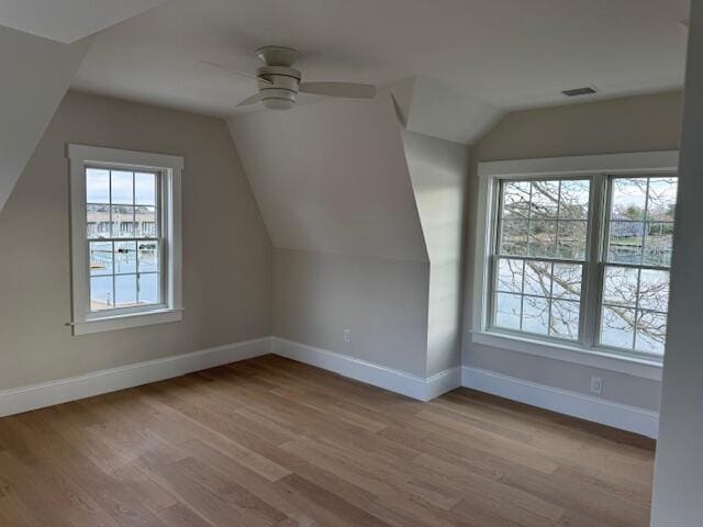 bonus room with light hardwood / wood-style floors, ceiling fan, and vaulted ceiling