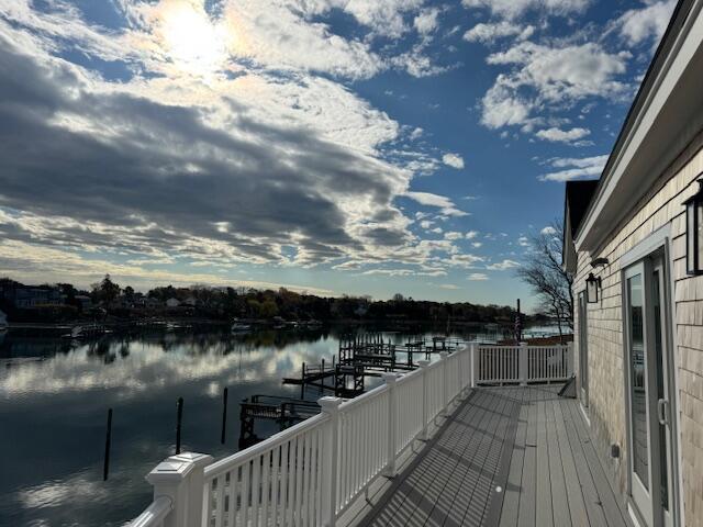 deck with a boat dock and a water view