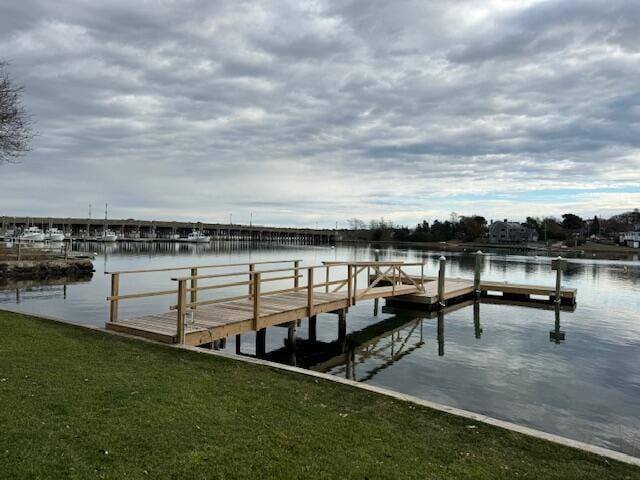 dock area featuring a water view and a yard