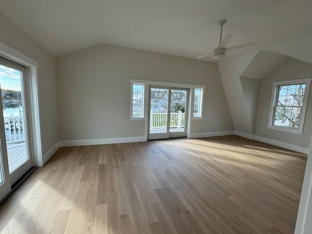 additional living space featuring ceiling fan, a healthy amount of sunlight, light hardwood / wood-style flooring, and lofted ceiling