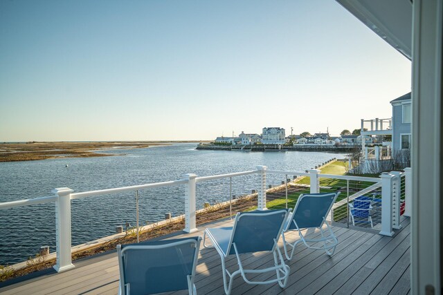 wooden deck featuring a water view