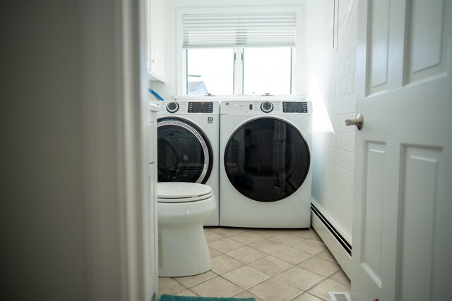 laundry room featuring separate washer and dryer, a baseboard heating unit, light tile patterned flooring, and visible vents