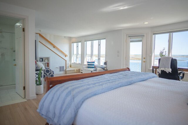 bedroom featuring connected bathroom, light wood finished floors, access to exterior, recessed lighting, and visible vents