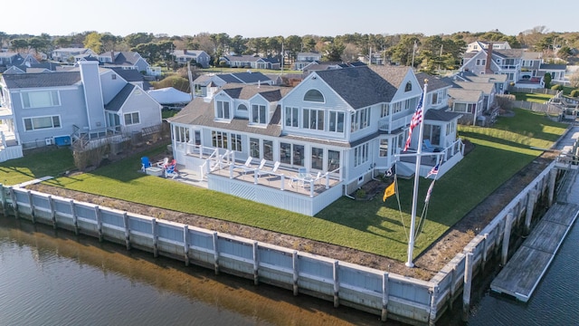 drone / aerial view with a residential view and a water view