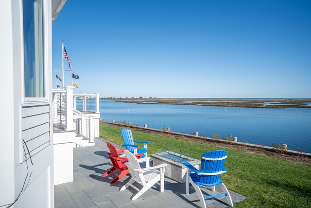 view of patio / terrace with a water view and an outdoor fire pit
