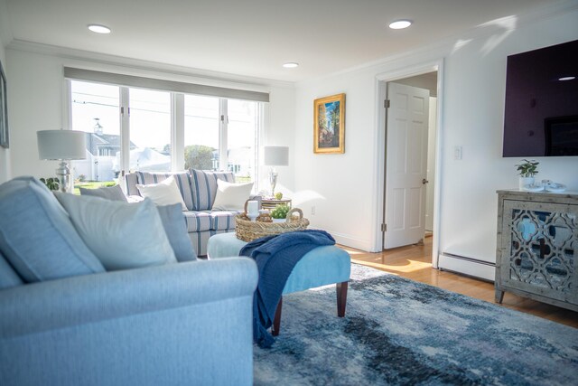 living area with a baseboard radiator, recessed lighting, and wood finished floors