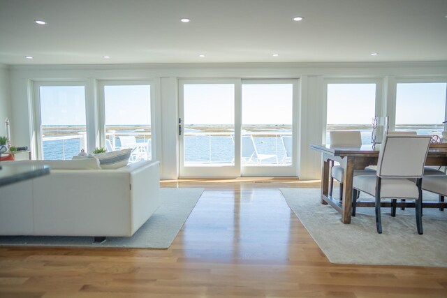 living room featuring crown molding, recessed lighting, and light wood finished floors