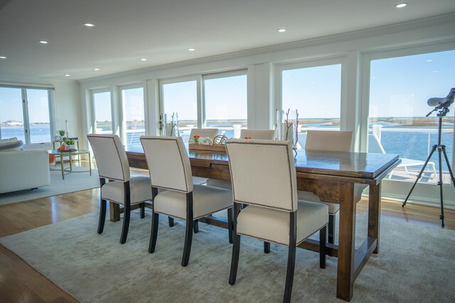 dining area with recessed lighting, ornamental molding, and wood finished floors