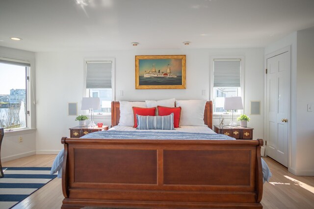 bedroom with recessed lighting, baseboards, and light wood-style floors