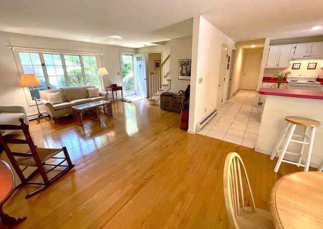 40 Appaloosa Way, Marstons Mills, MA 02648 - living area with a baseboard radiator, stairway, and light wood-style floors