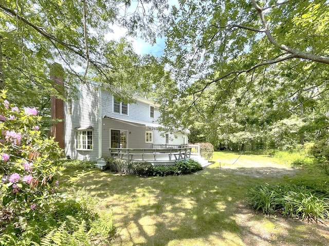 40 Appaloosa Way, Marstons Mills, MA 02648 - rear view of property with a wooden deck, a lawn, and a chimney