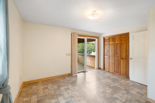 75 Wing Blvd E, East Sandwich, MA 02537 - unfurnished bedroom with light stone finish floors, access to exterior, and a closet