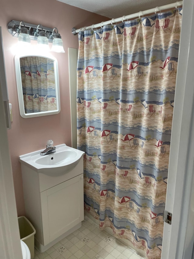 bathroom featuring vanity and a shower with shower curtain