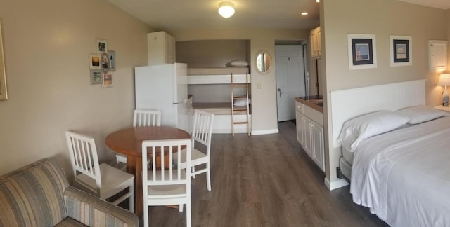 bedroom featuring dark hardwood / wood-style floors and white refrigerator