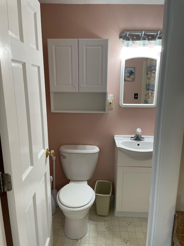 bathroom with toilet and vanity