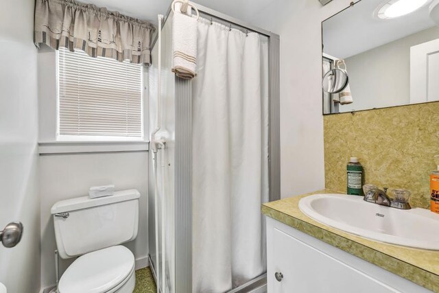 bathroom with toilet and vanity