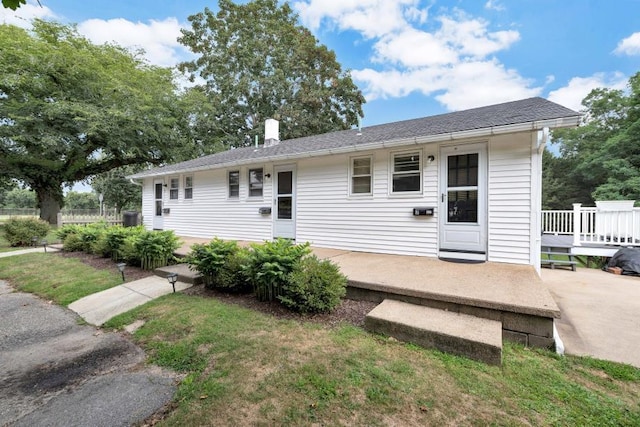 view of front of home featuring a front yard and a deck