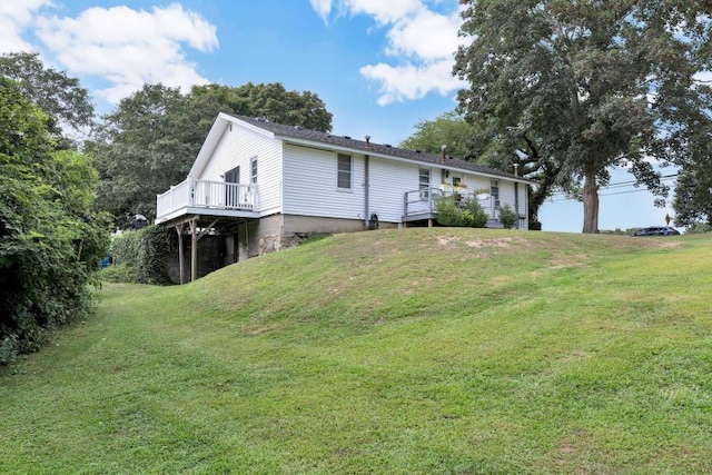 exterior space featuring a lawn and a deck
