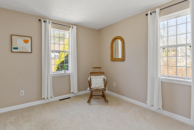 living area with visible vents, carpet flooring, and baseboards