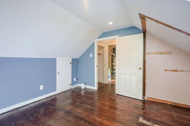 additional living space featuring lofted ceiling, baseboards, and hardwood / wood-style flooring