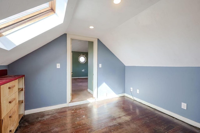 bonus room featuring vaulted ceiling with skylight, baseboards, hardwood / wood-style floors, and recessed lighting