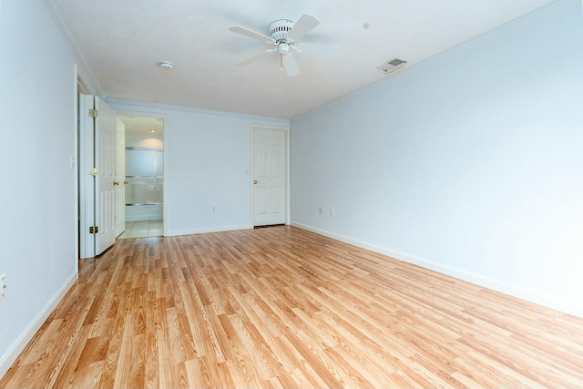 unfurnished bedroom with light wood finished floors, visible vents, ensuite bathroom, ornamental molding, and baseboards