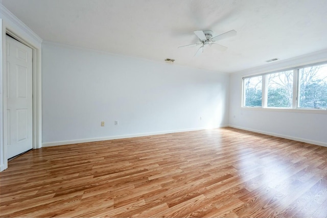 unfurnished room with light wood-type flooring, baseboards, and visible vents