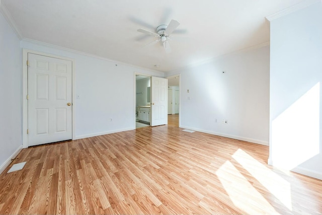 unfurnished room with light wood-style flooring, baseboards, and crown molding