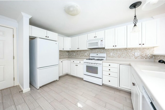 kitchen featuring tasteful backsplash, white appliances, light countertops, and white cabinetry