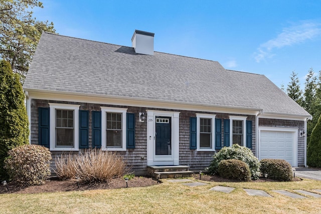 cape cod house featuring a garage, roof with shingles, a front lawn, and aphalt driveway