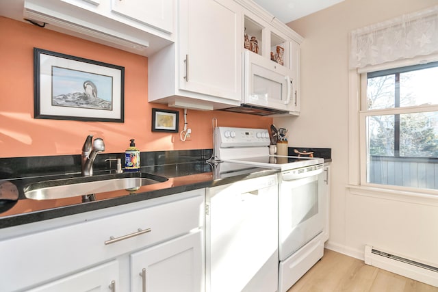 14 Harold St Unit 6-D, Harwich Port, MA 02646 - kitchen featuring sink, white cabinets, white appliances, baseboard heating, and light wood-type flooring