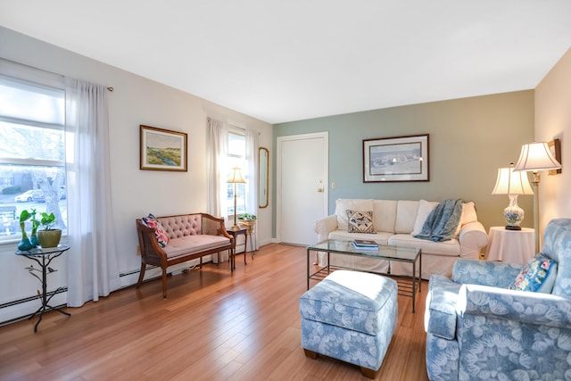 14 Harold St Unit 6-D, Harwich Port, MA 02646 - living room featuring a baseboard heating unit and light wood-type flooring