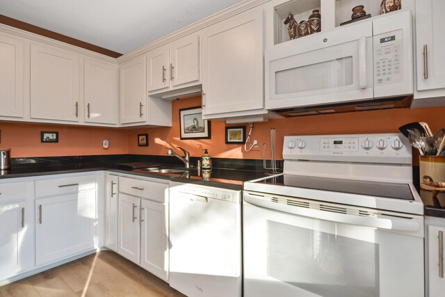 14 Harold St Unit 6-D, Harwich Port, MA 02646 - kitchen featuring white cabinetry, white appliances, sink, and light hardwood / wood-style flooring