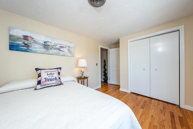 bedroom featuring light wood-type flooring and a closet