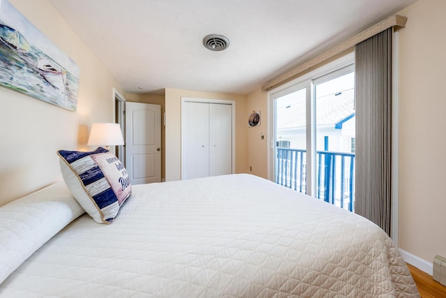 bedroom featuring a closet, light wood-type flooring, and access to outside