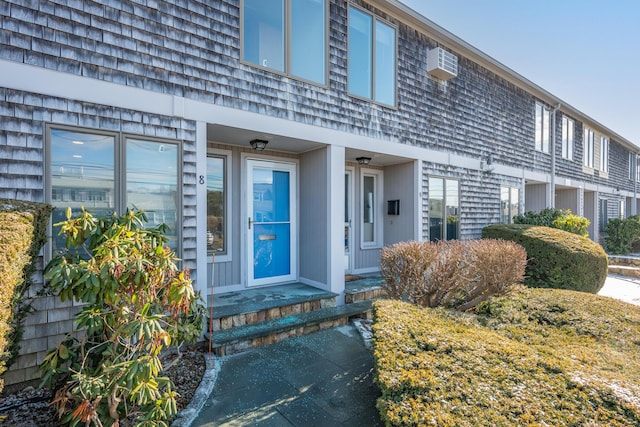 entrance to property featuring a wall mounted AC