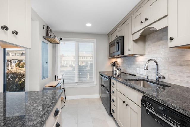 kitchen with sink, black appliances, plenty of natural light, and dark stone countertops