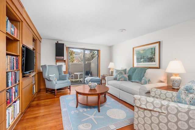 living room with hardwood / wood-style flooring and a textured ceiling