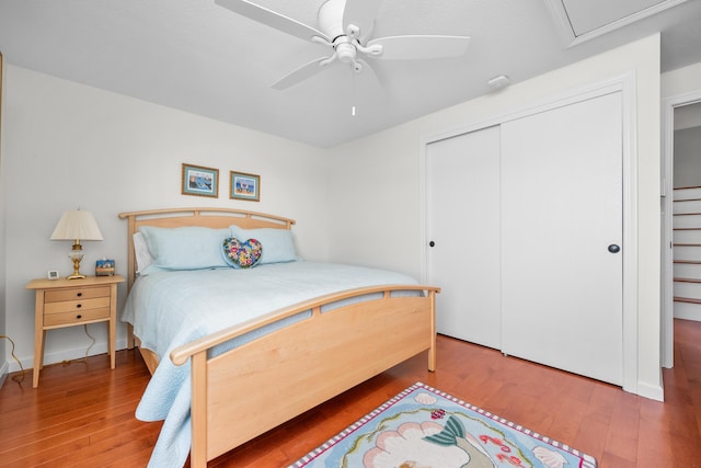 bedroom with a closet, ceiling fan, and hardwood / wood-style floors