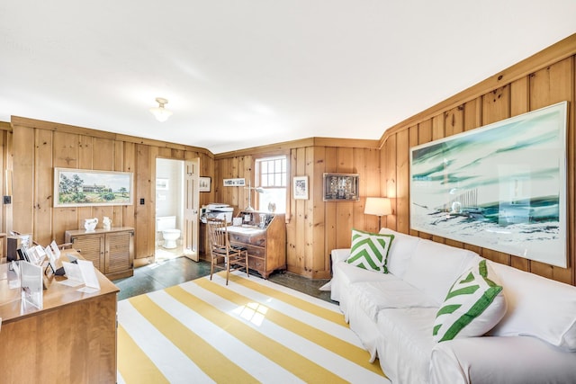 bedroom featuring wooden walls and ensuite bath