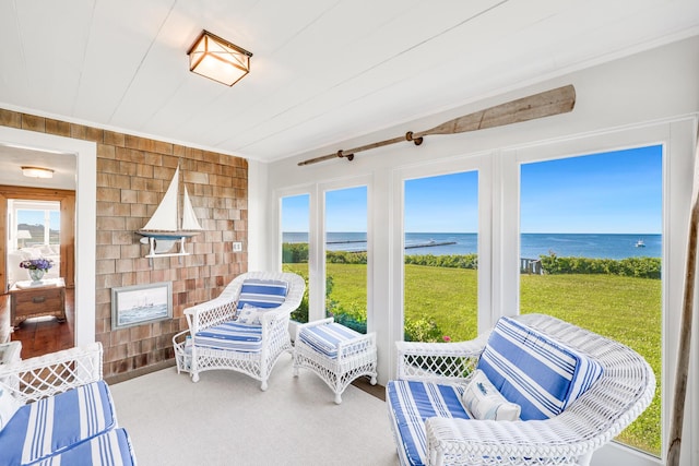 sunroom with a water view and a healthy amount of sunlight