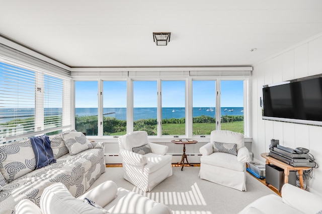 sunroom / solarium featuring a baseboard heating unit, a baseboard radiator, and a healthy amount of sunlight