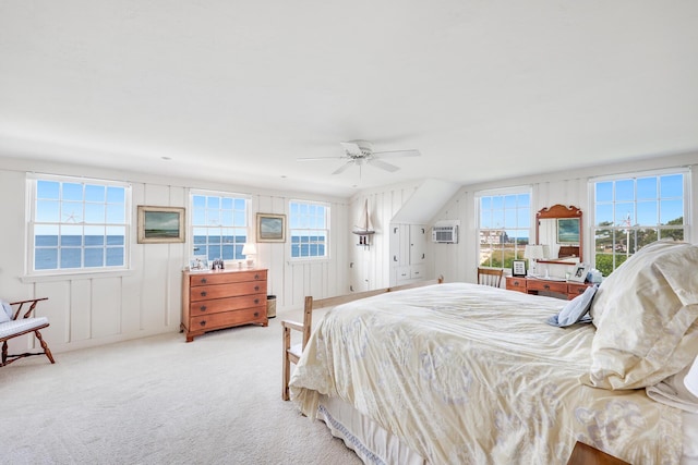 bedroom with ceiling fan, multiple windows, carpet flooring, and a wall mounted AC